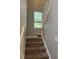 Staircase with neutral walls, and carpeted stairs with white trim at 1378 Runningbrook Dr, Avon, IN 46123