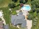 Aerial view of the property showing the pool, patio, playground, and surrounding landscaping at 13888 Smokey Ridge Dr, Carmel, IN 46033
