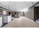 Open basement design with bar area featuring granite countertops, custom cabinetry, and pendant lighting fixtures at 13888 Smokey Ridge Dr, Carmel, IN 46033