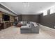 Basement with a gray sectional sofa, TV, media console and small windows for natural light at 13888 Smokey Ridge Dr, Carmel, IN 46033