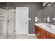 Modern bathroom featuring a glass enclosed shower and wood vanity with plenty of counter space at 13888 Smokey Ridge Dr, Carmel, IN 46033