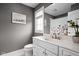 Bathroom featuring a sleek white vanity with marble countertop, modern faucet, and a decorative flower arrangement at 13888 Smokey Ridge Dr, Carmel, IN 46033