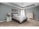 Comfortable bedroom featuring a queen-size bed with decorative pillows, two side tables, and a chest of drawers at 13888 Smokey Ridge Dr, Carmel, IN 46033