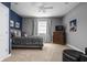 Comfortable bedroom featuring a queen bed, gray walls, carpet flooring, and a ceiling fan at 13888 Smokey Ridge Dr, Carmel, IN 46033