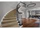 Elegant foyer featuring a curved staircase and hardwood floors at 13888 Smokey Ridge Dr, Carmel, IN 46033