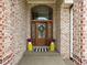 Inviting front entrance with a wood door and decorative accents at 13888 Smokey Ridge Dr, Carmel, IN 46033
