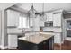 A kitchen with a large island, granite countertops, custom cabinets and modern appliances at 13888 Smokey Ridge Dr, Carmel, IN 46033
