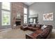 Inviting living room with a brick fireplace and large windows at 13888 Smokey Ridge Dr, Carmel, IN 46033