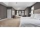 Bright main bedroom boasts a fireplace, sitting area, and neutral color scheme at 13888 Smokey Ridge Dr, Carmel, IN 46033