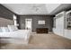 Spacious main bedroom featuring custom built-ins, tray ceilings, and neutral color scheme at 13888 Smokey Ridge Dr, Carmel, IN 46033