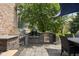Outdoor kitchen with stone accents and stainless steel appliances, perfect for summer grilling at 13888 Smokey Ridge Dr, Carmel, IN 46033