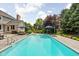 Inground pool with diving board and patio furniture surrounded by a spacious yard at 13888 Smokey Ridge Dr, Carmel, IN 46033