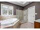 Relax in this spacious bathroom featuring a separate shower and tub with great natural light at 13888 Smokey Ridge Dr, Carmel, IN 46033