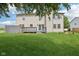 Spacious backyard featuring a well-maintained lawn, a wooden deck, and a sliding glass door at 13938 Charleswood Ct, Fishers, IN 46038