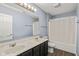 Well-lit bathroom features a double sink vanity and a shower/tub combo at 13938 Charleswood Ct, Fishers, IN 46038
