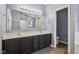 Bathroom featuring double sink vanity, a large mirror and modern fixtures at 13938 Charleswood Ct, Fishers, IN 46038
