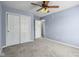 This is a bedroom with a ceiling fan and double door closet at 13938 Charleswood Ct, Fishers, IN 46038