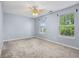 This bedroom has neutral carpet, blue walls, and two windows with natural light at 13938 Charleswood Ct, Fishers, IN 46038