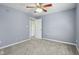 Neutral bedroom featuring a ceiling fan and an open doorway at 13938 Charleswood Ct, Fishers, IN 46038