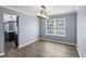 Dining room featuring wood-look floors, modern light fixture, and open to kitchen at 13938 Charleswood Ct, Fishers, IN 46038