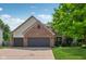 Charming brick home featuring an attached two-car garage and a well-manicured front lawn at 13938 Charleswood Ct, Fishers, IN 46038