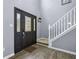 Bright foyer showcasing a decorative front door, staircase, and luxury vinyl plank flooring at 13938 Charleswood Ct, Fishers, IN 46038