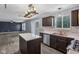 Bright kitchen with stainless appliances, granite countertops, an island, and an open layout to the living area at 13938 Charleswood Ct, Fishers, IN 46038