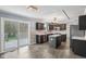 Spacious kitchen with dark wood cabinets, stainless steel appliances, and luxury vinyl plank flooring at 13938 Charleswood Ct, Fishers, IN 46038
