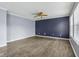 Bright living room featuring wood-look flooring, ceiling fan, and neutral gray walls at 13938 Charleswood Ct, Fishers, IN 46038