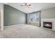 Spacious living room featuring a fireplace, ceiling fan and large window at 13938 Charleswood Ct, Fishers, IN 46038