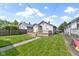 A pleasant backyard features a grassy lawn, wooden deck, and privacy fence at 141 S 9Th Ave, Beech Grove, IN 46107