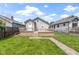 A well-maintained backyard has a charming deck, green grass, and mature trees at 141 S 9Th Ave, Beech Grove, IN 46107
