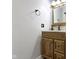 Traditional bathroom boasts a wood vanity, cream countertop, and neutrally painted walls at 141 S 9Th Ave, Beech Grove, IN 46107