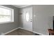 Entryway with a white door featuring an oval window, gray walls, and stylish laminate flooring at 141 S 9Th Ave, Beech Grove, IN 46107