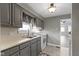 Well-lit kitchen with gray cabinets, stainless steel sink, and a modern electric range at 141 S 9Th Ave, Beech Grove, IN 46107