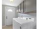 Functional laundry room with a newer Samsung washer and dryer and a door to the exterior at 141 S 9Th Ave, Beech Grove, IN 46107