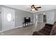 Bright living room with neutral walls, ceiling fan, laminate floors, and a view into adjoining rooms at 141 S 9Th Ave, Beech Grove, IN 46107