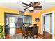 This dining room has wood floors, a ceiling fan, and transitions into the living room space with neutral walls at 1619 E Bradbury Ave, Indianapolis, IN 46203