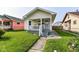 Inviting home exterior with a quaint porch, steps, and lush green lawn at 1619 E Bradbury Ave, Indianapolis, IN 46203