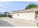 View of a one-car garage with concrete driveway, siding, and a window at 1619 E Bradbury Ave, Indianapolis, IN 46203