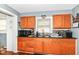 Well-lit kitchen with wooden cabinets, granite counters, and modern sink at 1619 E Bradbury Ave, Indianapolis, IN 46203