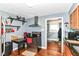 Efficient kitchen with modern appliances, shelving, and seamless transition to the hall at 1619 E Bradbury Ave, Indianapolis, IN 46203