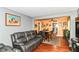Cozy living room flowing into a dining area with hardwood floors and a leather sofa at 1619 E Bradbury Ave, Indianapolis, IN 46203