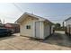 This is a detached outbuilding with vinyl siding, a new roof, a concrete parking pad, and an exterior door at 1619 E Bradbury Ave, Indianapolis, IN 46203