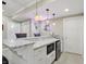 Basement bar features granite countertop with barstool seating, a beverage fridge, and stylish lighting at 16802 Oak Manor Dr, Westfield, IN 46074