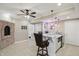 Basement bar area features tile floors, brick fireplace, modern ceiling fan and a granite countertop at 16802 Oak Manor Dr, Westfield, IN 46074