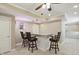 Basement bar area features tile floors, modern ceiling fan and a granite countertop with barstool seating at 16802 Oak Manor Dr, Westfield, IN 46074