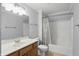 Well-lit bathroom features a shower/tub combo, white toilet, and wooden vanity with a large mirror at 16802 Oak Manor Dr, Westfield, IN 46074