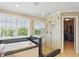 Bathroom featuring a soaking tub, a glass shower, and a view into the walk-in closet at 16802 Oak Manor Dr, Westfield, IN 46074