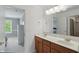 Bathroom with double sinks and a view into a bedroom at 16802 Oak Manor Dr, Westfield, IN 46074